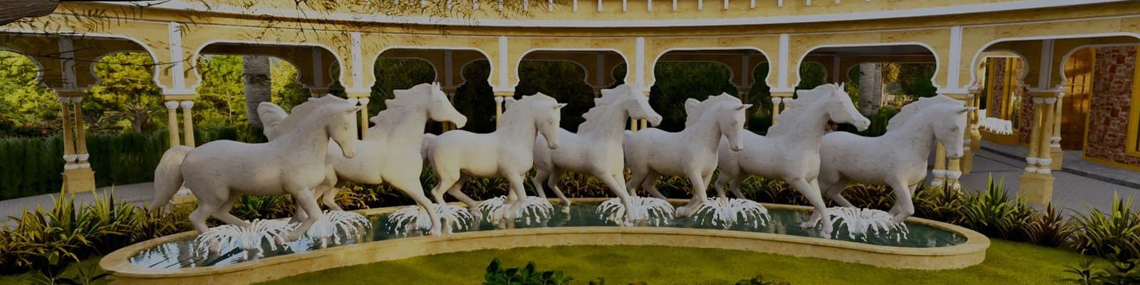 The seven white-horse fountain in the arched colonnade courtyard at Sonagarh Fort Resort